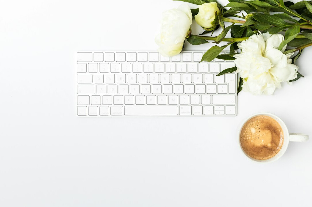 Desk with a keyboard and a cup of coffee