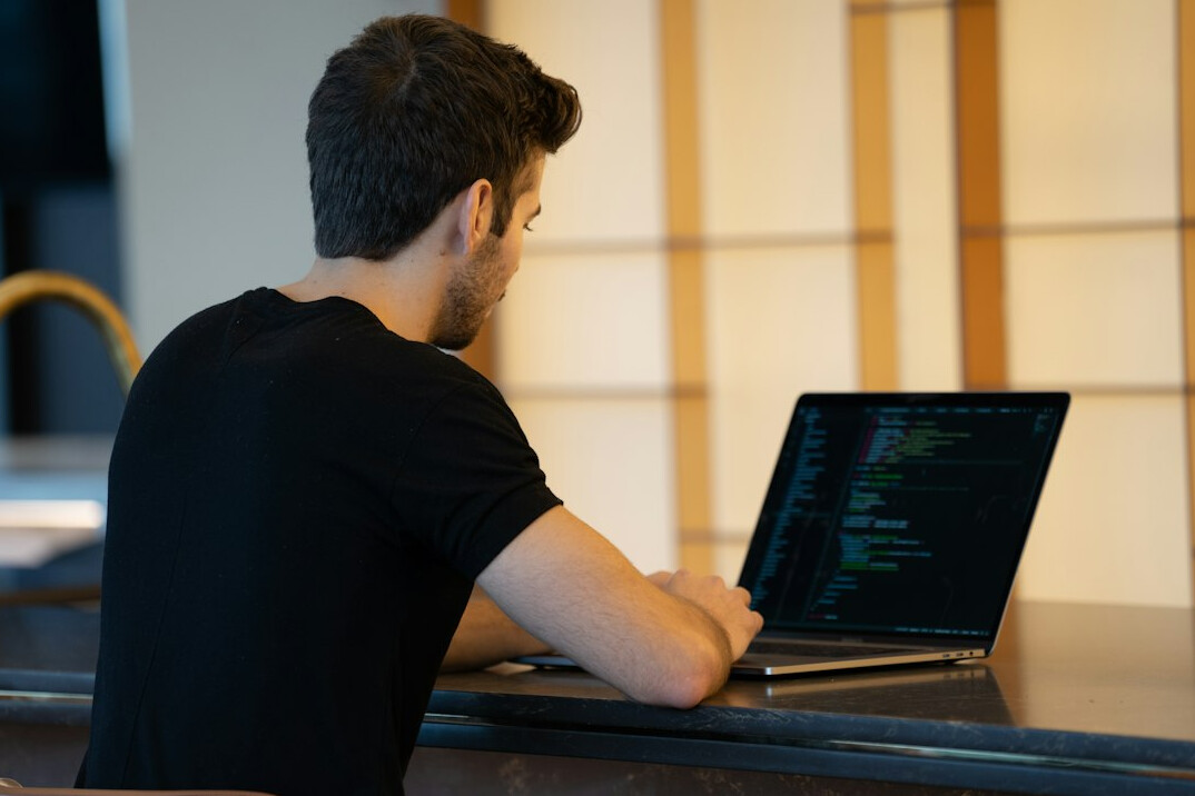 person learning programming on laptop