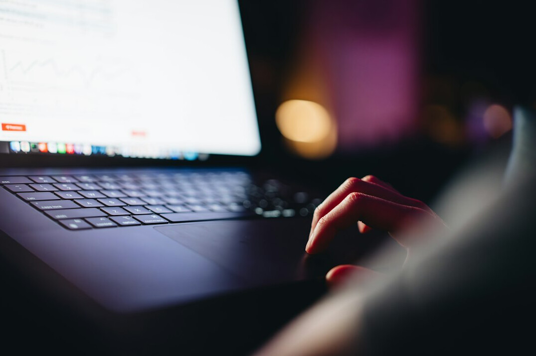 programmer typing on laptop