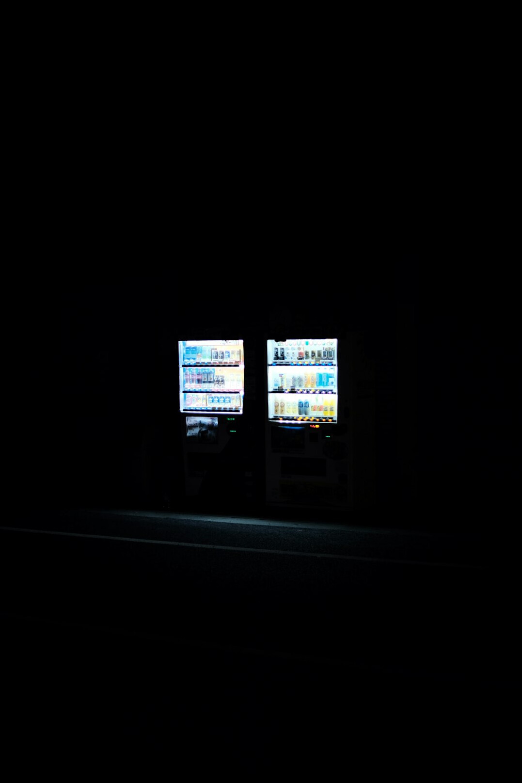 Two monitors displaying software code side by side