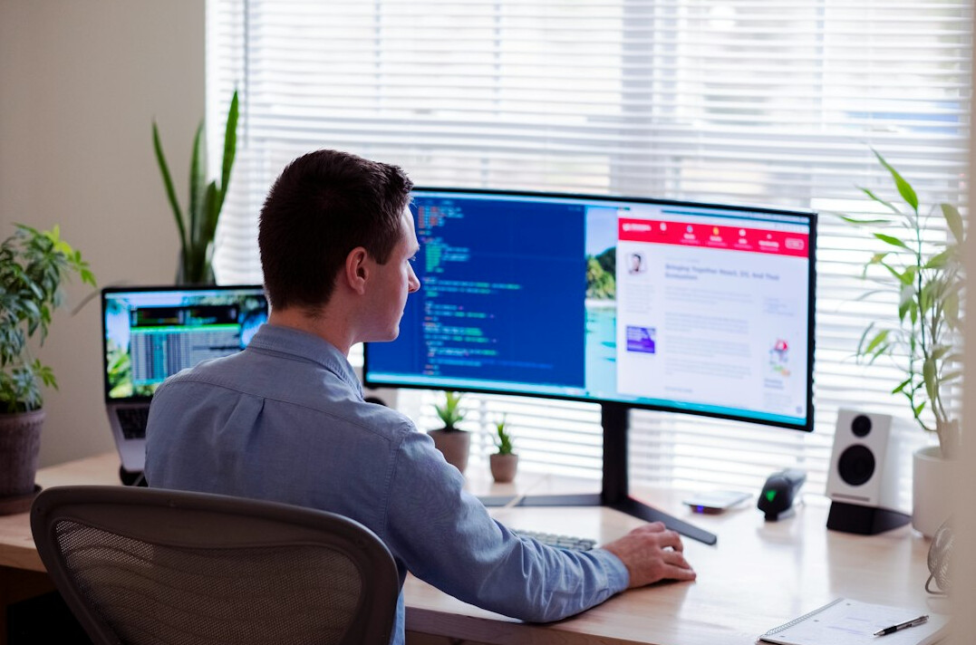 successful programmer at desk